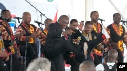 FILE - South African President Cyril Ramaphosa, center, dances to music as he attends Freedom Day celebrations in Pretoria, South Africa, on April 27, 2024.