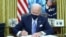 U.S. President Joe Biden signs executive orders in the Oval Office of the White House in Washington, after his inauguration as the 46th President of the United States, January 20, 2021.