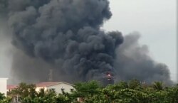 A view shows the fire at Hlaing Thar Yar factory, in Yangon, Myanmar, March 14, 2021, in this still image obtained by Reuters from a social media video.