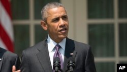 President Barack Obama, accompanied by Vice President Joe Biden, speaks in the Rose Garden of the White House in Washington, July 1, 2015. 