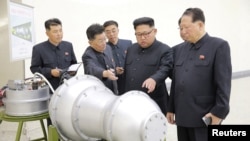 FILE - North Korean leader Kim Jong Un, center, provides guidance on a nuclear weapons program in this undated photo released by North Korea's Korean Central News Agency (KCNA) in Pyongyang, Sept. 3, 2017. 