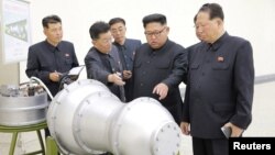 North Korean leader Kim Jong Un, center, provides guidance on a nuclear weapons program in this undated photo released by North Korea's Korean Central News Agency (KCNA) in Pyongyang, North Korea, Sept. 3, 2017.