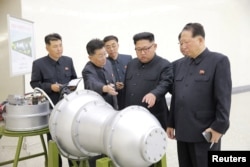 North Korean leader Kim Jong Un, center, provides guidance on a nuclear weapons program in this undated photo released by North Korea's Korean Central News Agency (KCNA) in Pyongyang, Sept. 3, 2017.