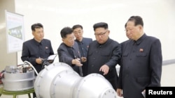 FILE - North Korean leader Kim Jong Un, center, provides guidance on a nuclear weapons program in this undated photo released by North Korea's Korean Central News Agency (KCNA) in Pyongyang, Sept. 3, 2017.