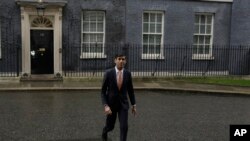British lawmaker Rishi Sunak, and Chancellor of the Exchequer leaves 10 Downing Street, where he was given the job by Britain's Prime Minister Boris Johnson, as the former Chancellor Sajid Javid, resigned, Feb. 13, 2020.