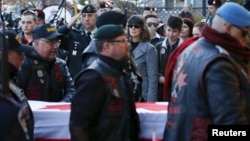 FILE - Pallbearers carry the casket of John Gallagher, a Canadian volunteer fighter and former Canadian forces member who was killed fighting alongside Kurdish forces in Syria against the Islamic State group, Ontario, Canada, Nov. 20, 2015.