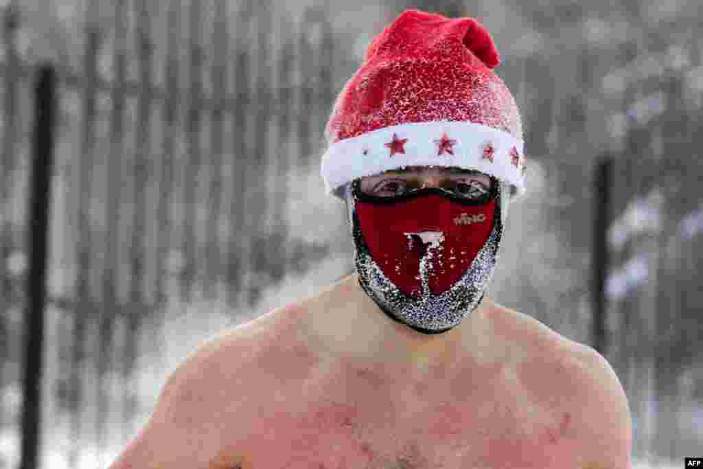 A member of the ice swimming club prepares to swim in the icy water as the temperature drops down to -34&deg;C (-29&deg;F), in the Siberian city of Novosibirsk, Russia, Dec. 26, 2020.