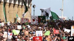 FILE - Demonstrators take the streets of Algiers, April 9, 2021. A crowd of protesters marched in the streets of Algeria capital Algiers in support for the Hirak pro-democracy movement.