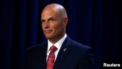 Acting director of the Immigration and Customs Enforcement agency (ICE) Ronald Vitiello listens as U.S. Vice President Mike Pence delivers remarks at ICE headquarters in Washington, July 6, 2018. 