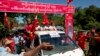 FILE - Supporters of Myanmar political leader Aung San Suu Kyi's National League for Democracy party follow her vehicle at a campaign rally in western Rakhine state, Myanmar, Oct. 17, 2015.