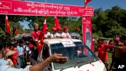 FILE - Supporters of Myanmar political leader Aung San Suu Kyi's National League for Democracy party follow her vehicle at a campaign rally in western Rakhine state, Myanmar, Oct. 17, 2015.