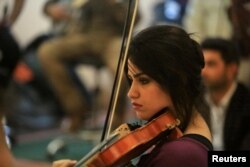 Hadeer Saad plays the violin with the Iraqi Symphony Orchestra in Mosul, Oct. 26, 2018.