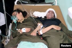 Schoolgirls lie on a stretcher at a hospital after they were injured by an airstrike near their school in Saada, Yemen, April 9, 2018.