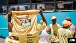 FILE - Supporters of candidate for South Africa's ruling African National Congress (ANC) party leadership Nkosazana Dlamini-Zuma hold T-shirts as they arrive to hear her speak during her final campaign at a rally in Clermont township south of Durban, Dec. 9, 2017.