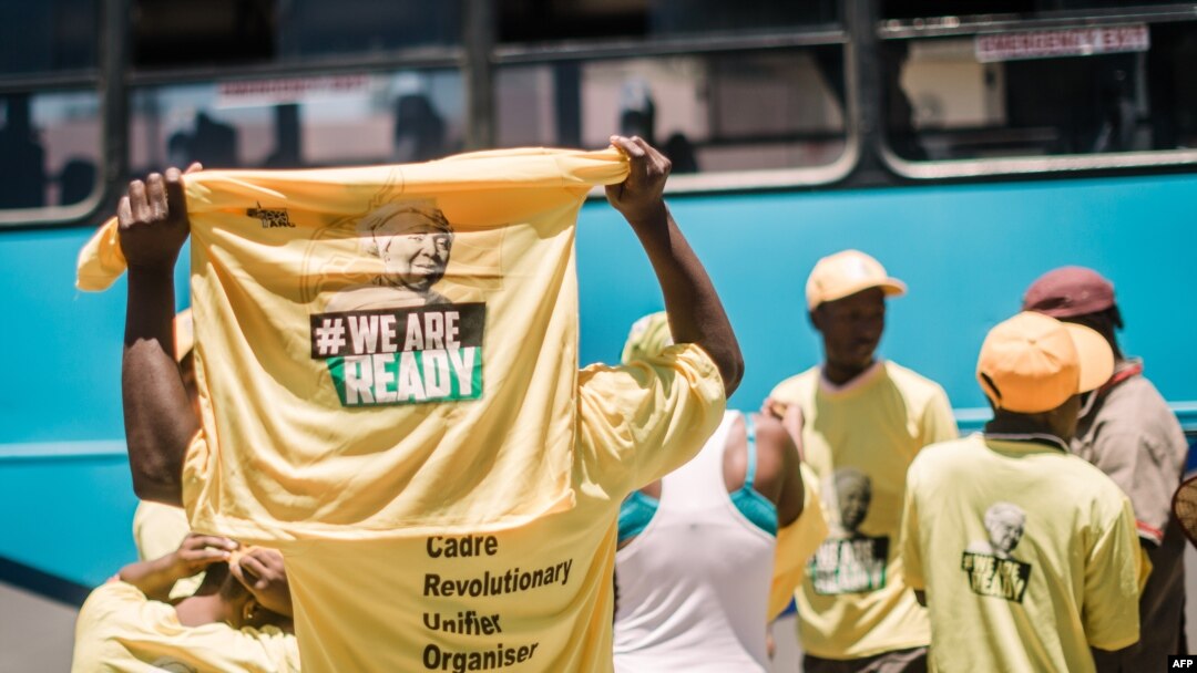 FILE - Supporters of candidate for South Africa's ruling African National Congress (ANC) party leadership Nkosazana Dlamini-Zuma hold T-shirts as they arrive to hear her speak during her final campaign at a rally in Clermont township south of Durban, Dec. 9, 2017.