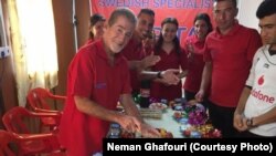 FILE - Leland Scott celebrates his birthday with his students at the Bajid Kandall 2 Yazidi refugee camp in Iraqi Kurdistan region, May 17, 2016.