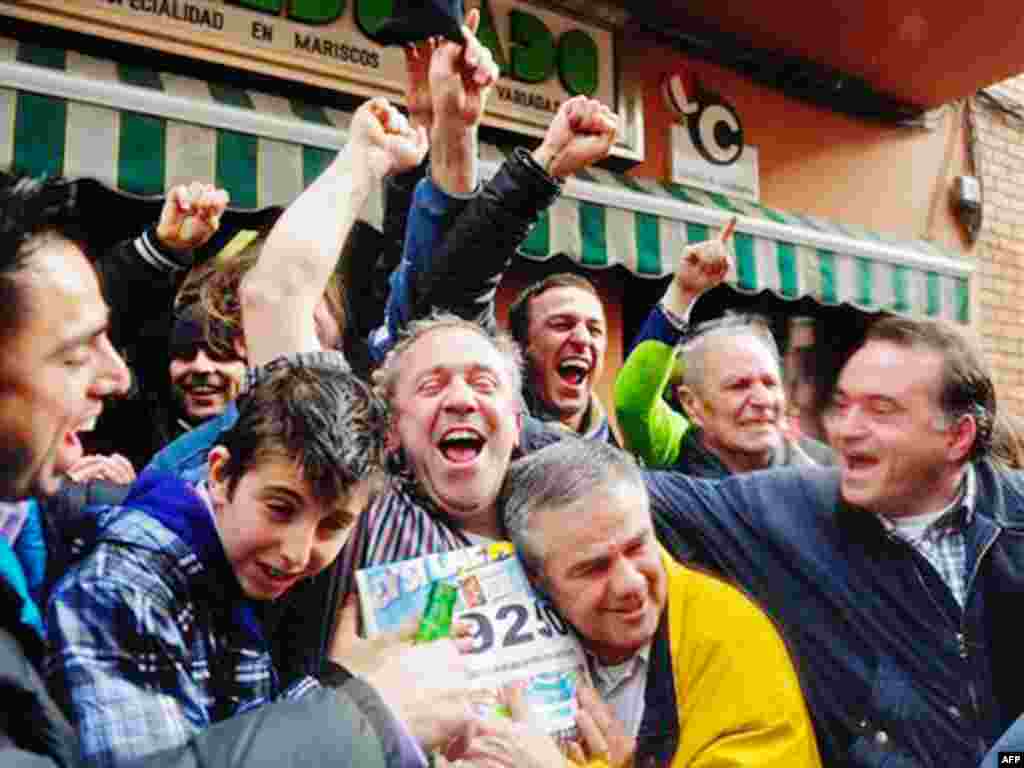 People celebrate after winning a portion of the main prize of Spain's Christmas lottery in Palleja, Spain, Wednesday, Dec. 22, 2010. Spain's beloved Christmas lottery known as "El Gordo" (The Fat One) spread euro2.3 billion ($3 billion) in holiday cheer W