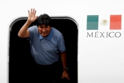 Former Bolivian President Evo Morales waves upon arrival to Mexico City, , Nov. 12, 2019. Mexico granted asylum to Morales, who resigned on Nov. 10 under mounting pressure from the military and the public.