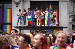 FILE - People attend the annual Pride in London parade, in London, Britain, July 6, 2019.