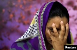 A survivor of slavery who wished to remain anonymous poses for a picture in New Delhi, March 7, 2018.