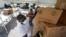 City worker Randy Greice, foreground, unloads a pallet of food at a food distribution event, Oct. 6, 2020, in Opa-locka, Florida.