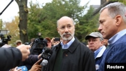 Pennsylvania Gov. Tom Wolf and Wendell Hissrich, right, Pittsburgh public safety director, speak to media, after a gunman opened fire at the Tree of Life synagogue in Pittsburgh, Pa., Oct. 27, 2018.