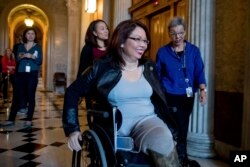 FILE - Sen. Tammy Duckworth, D-Ill. arrives for a closed-door Democratic policy luncheon on Capitol Hill in Washington.