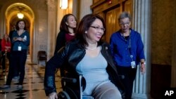 FILE - Sen. Tammy Duckworth, D-Ill. arrives for a closed-door Democratic policy luncheon on Capitol Hill in Washington.