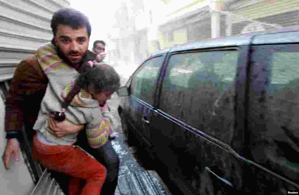 Civilians run to take cover after a jet missile hit the al-Myassar neighborhood of Aleppo, February 20, 2013. 