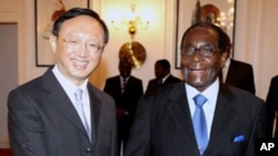 Zimbabwean President Robert Mugabe, right, welcomes the Chinese foreign affairs minister Yang Jiechi at State House in Harare, Zimbabwe, Friday, Feb. 11, 2011. Yang is in the country on a two day working visit.