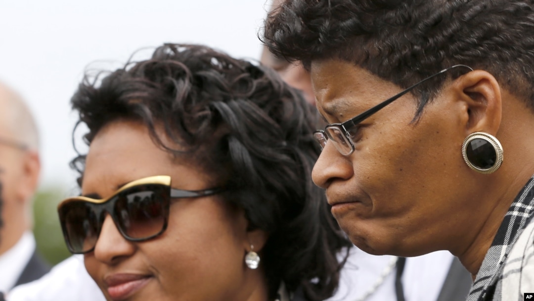 FILE - Kadiatou Diallo, left, attends a graveside ceremony honoring Emmett Till in Alsip, Ill., Aug. 28, 2015. The boy's murder 60 years earlier in Mississippi galvanized U.S. civil rights activists. 