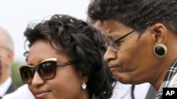 FILE - Kadiatou Diallo, left, attends a graveside ceremony honoring Emmett Till in Alsip, Ill., Aug. 28, 2015. The boy's murder 60 years earlier in Mississippi galvanized U.S. civil rights activists. 