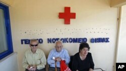 Local residents sit outside of the town's hospital in the town of Thebes, about 88 kilometers northwest of Athens, June 2011. (file photo)