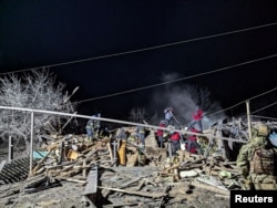 Rescuers work at the site of a Russian missile strike in an area of the Pokrovsk town, amid Russia's attack on Ukraine, in Donetsk region, Ukraine January 6, 2024