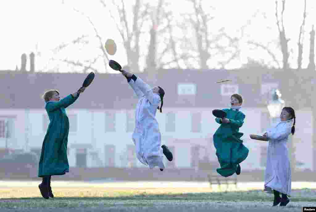 Probationer choristers of Salisbury Cathedral Choir practice flipping pancakes ahead of Shrove Tuesday at Salisbury Cathedral, Salisbury, Britain.