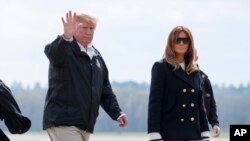 FILE - President Donald Trump and first lady Melania Trump walk from Marine One to board Air Force One at Lawson Army Airfield, Fort Benning, Ga., en route Palm Beach International Airport in West Palm Beach, Fla., March 8, 2019 photo.