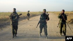 FILE - Ethiopian soldiers check for landmines on a road leading to the border town of Badme, Nov. 5, 2008. 