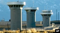 FILE - In this Feb. 21, 2007, file photo, guard towers loom over the administrative maximum security federal prison called Supermax near Florence, Colo. (Chris McLean/The Pueblo Chieftain via AP)