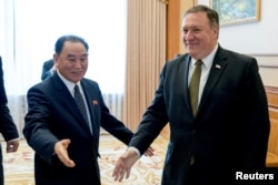 FILE - Secretary of State Mike Pompeo, right, and Kim Yong Chol, a North Korean senior ruling party official, arrive for a lunch at the Park Hwa Guest House in Pyongyang, North Korea, July 7, 2018.