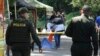 A forensic investigator inspects the remains of a man killed when a motorcycle loaded with explosives detonated at a police checkpoint in Las Peñas community of Jamundi, Colombia, Dec. 7, 2024.