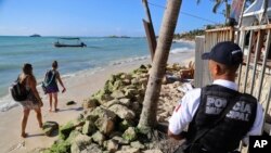 FILE - Police guard the exit of the Blue Parrot nightclub in Playa del Carmen, Mexico, Jan. 16, 2017. 