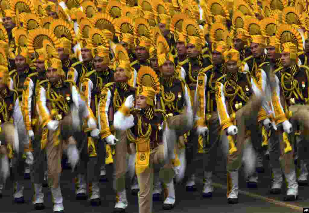 Para tentara India memberikan salut saat berbaris di Tajpath, sebuah upacara di jalan yang dimulai dengan berjalan dari Istana Presiden India menuju gerbang peringatan perang India, dalam latihan dengan pakaian lengkap menjelang&nbsp; parade Hari Republik di New Delhi. &nbsp;