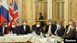 FILE - Iran's chief nuclear negotiator Ali Bagheri Kani and members of the Iranian delegation wait for the start of a meeting of the JCPOA Joint Commission in Vienna, Austria, Nov. 29, 2021. (EU Delegation in Vienna/Handout via Reuters)