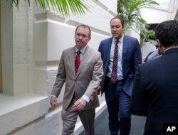 Budget Director Mick Mulvaney, left, with Rep. Will Hurd, R-Texas, a member of the House Intelligence Committee, leaves a meeting with President Donald Trump at the Capitol in Washington, March 21, 2017.