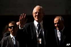 FILE - Peru's President Pedro Pablo Kuczynski waves as he arrives to an economic forum about Peru after his meeting with Spain's Prime Minister Mariano Rajoy in Madrid, Spain, June 12, 2017.