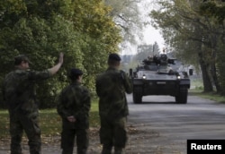 FILE - German army soldiers arrive for a NATO military drill, Oct. 4, 2015, in Adazi, Latvia. With signs growing of a thaw between Moscow and Western capitals, some of Russia's neighbors fear a dip in European resolve over the Ukraine crisis.