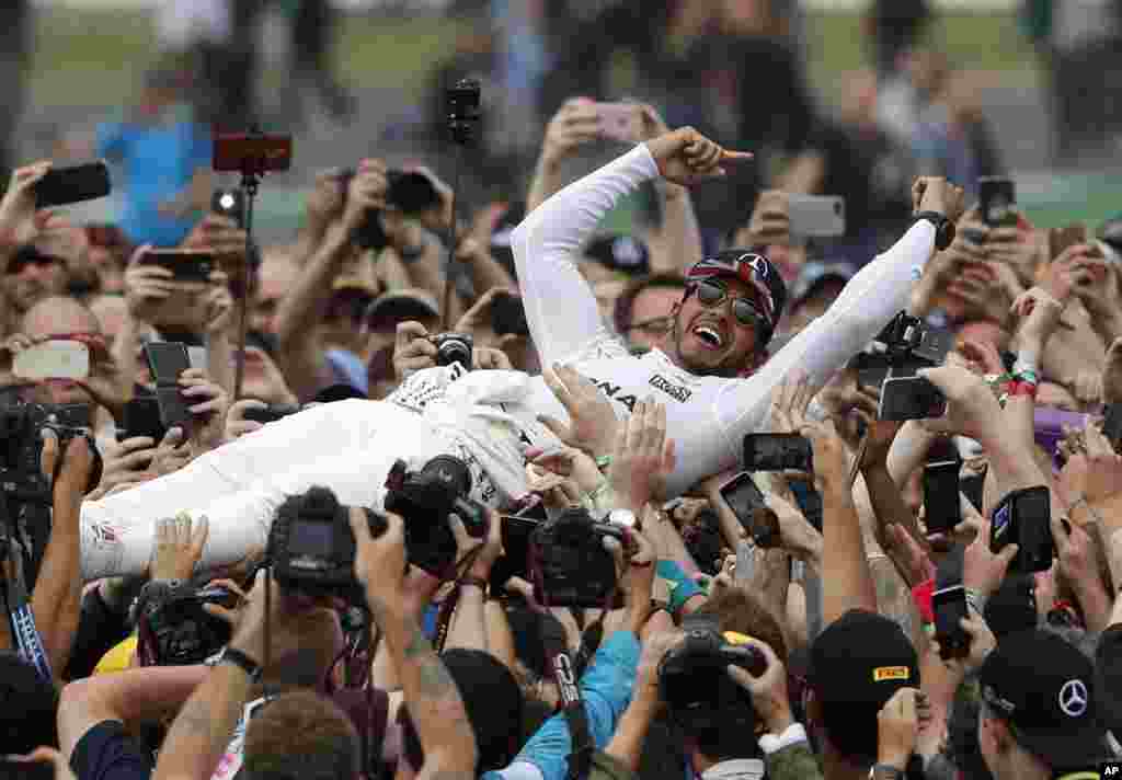 Mercedes driver Lewis Hamilton of Britain celebrates after winning the British Formula One Grand Prix at the Silverstone racetrack in Silverstone.