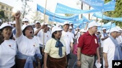 An unidentified Cambodian woman raises her fist and cheers during the celebration of International Human Rights Day rally in the capital Phnom Penh, Monday, Dec. 10. 2007. 
