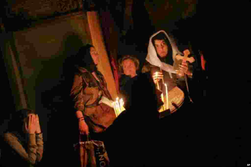 Christian worshippers pray in the Golgotha, or Calvary, inside the Church of the Holy Sepulchre, traditionally believed to be the burial site of Jesus Christ, in Jerusalem's Old City, Wednesday, April 11, 2012. (AP Photo/Bernat Armangue)