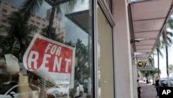 FILE - A 'For Rent' sign hangs on a closed shop during the coronavirus pandemic in Miami Beach, Fla., July 13, 2020. 